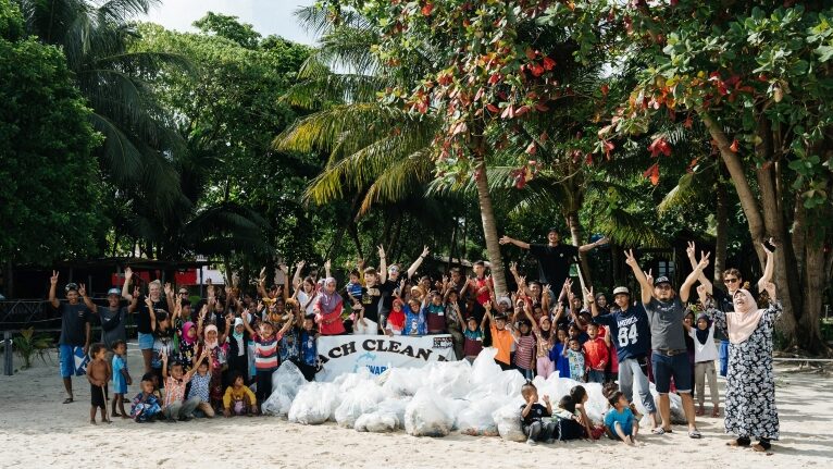 Scuba Junkie Mabul Staff and Guests with the Debris collected after a Beach Cleanup.