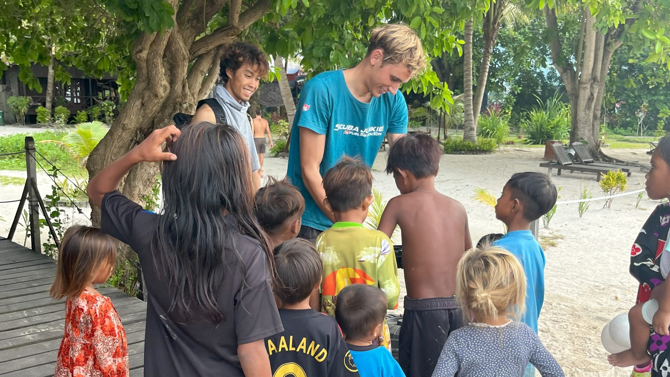 Local kids from Mabul Island helping Instructor Shannon in the recollection of Debris. Beach cleanups encourage community involvement